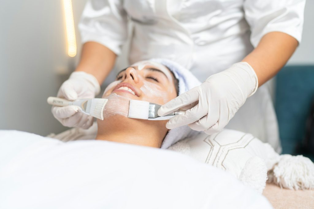 Woman receiving a professional skin peeling treatment in spa